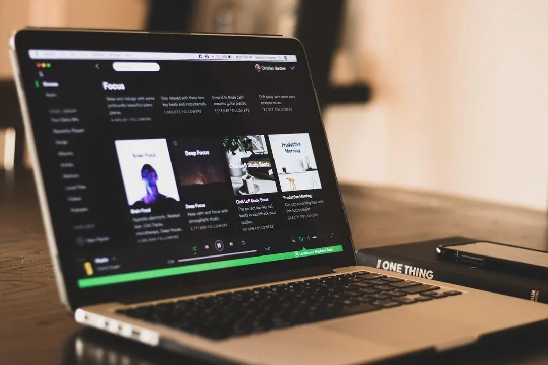 Designer working with headphones on, using music to boost creativity